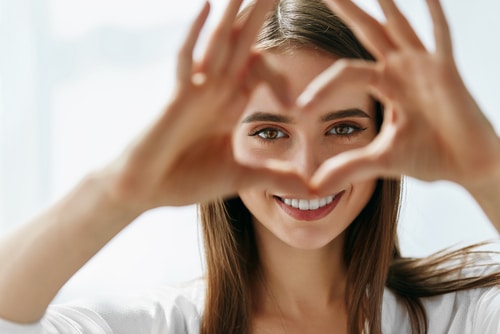 Person making a heart with their fingers - patient resources